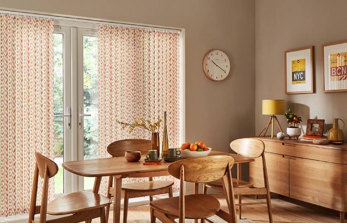 A view of a dining room with beautiful vertical blinds
